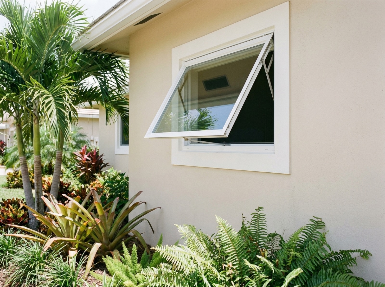 Awning impact window propped open on a Florida home
